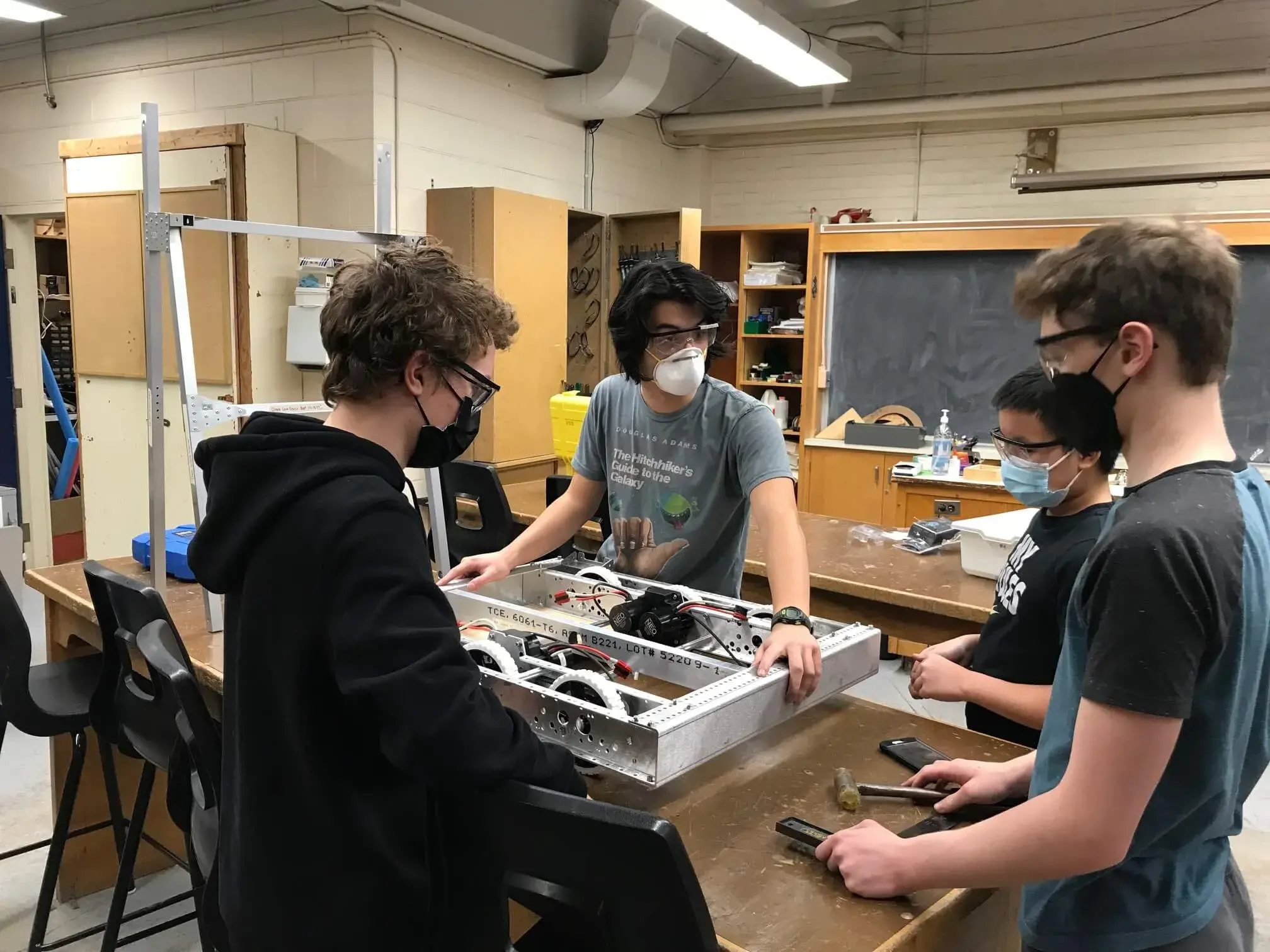 Eamonn, Isaac, Jacob and Koby standing around our half finished 2022 robot Sharpie